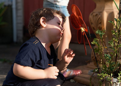 Portrait of a cute young boy playing in the backyard