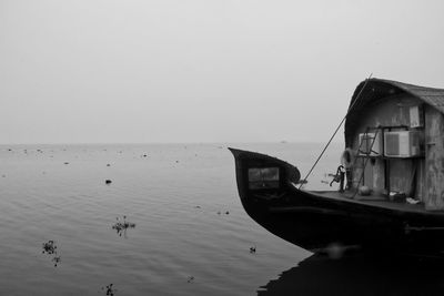 Houseboat on lake during foggy weather