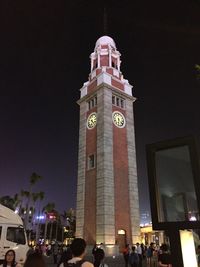 Low angle view of illuminated buildings against sky at night