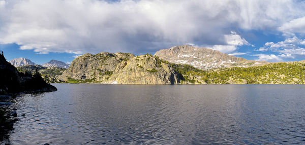 Panoramic view of sea and mountains against sky