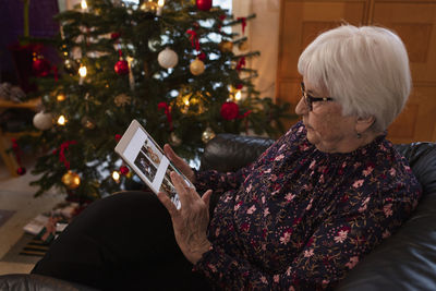 Senior woman using digital tablet at home