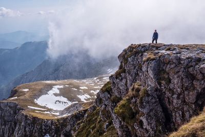 Man standing on mountain against sky