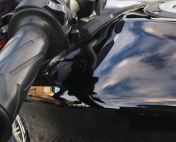 Close-up of man driving car against sky