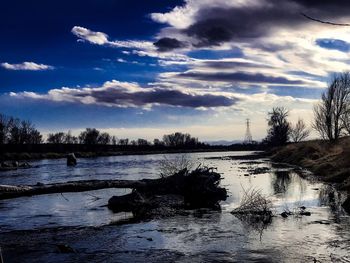 Scenic view of river against sky during winter