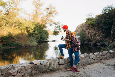 Man standing by lake against trees