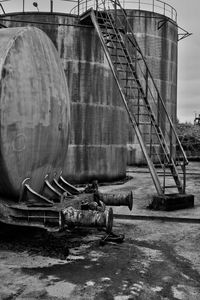 Wagon in front of an oil tank