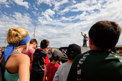 Rear view of people enjoying friends against sky