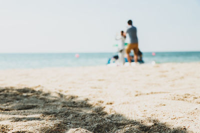 People on beach against sky