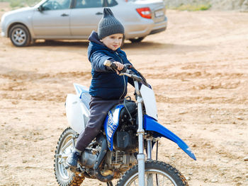 Cute toddler boy smiling on a motorcycle