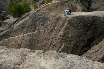 Rear view of man walking on rock