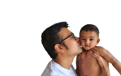 Portrait of father and son against white background