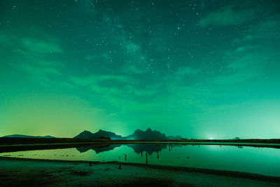 Scenic view of lake against sky at night