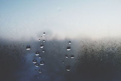 Close-up of raindrops on glass window