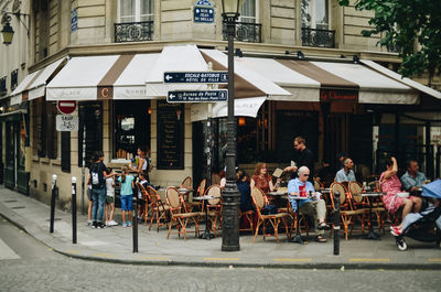 People at sidewalk cafe in city