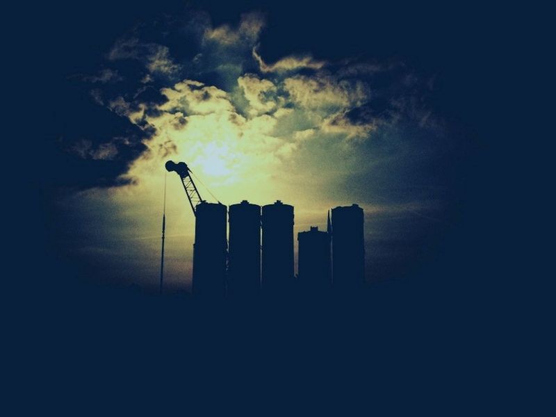 sky, building exterior, architecture, built structure, silhouette, low angle view, cloud - sky, sunset, cloudy, tower, tall - high, city, dusk, skyscraper, building, cloud, outdoors, dark, no people, weather