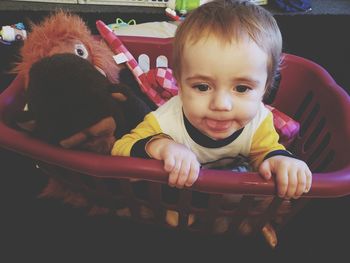 Portrait of cute boy with toy at home