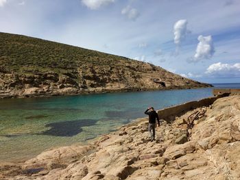 Rear view of man standing on shore