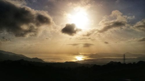Scenic view of silhouette mountain against sky at sunset