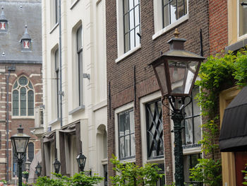 Low angle view of street light by building