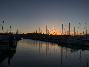 Sailboats in marina at sunset