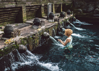 High angle view of woman standing in water