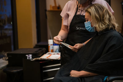 Midsection of couple holding hands