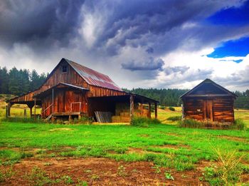 Abandoned house on field against sky