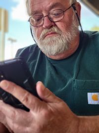 Midsection of man using mobile phone