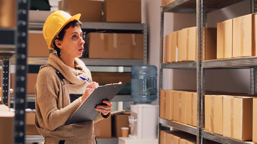 Portrait of young woman standing in store