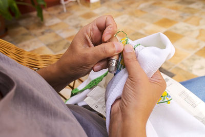 Close-up of woman weaving fabric