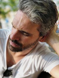 Close-up of bearded mid adult man resting outdoors