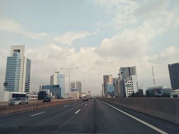 City street and modern buildings against sky