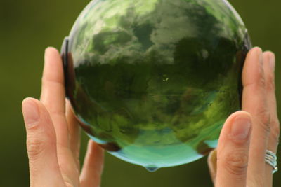 Close-up of hand holding crystal ball