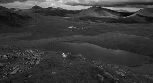 Barren landscape against clouds