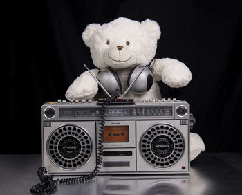 Close-up of stuffed toy on table against black background