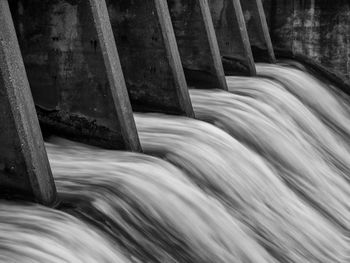 Close-up of dam against river