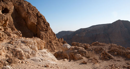 Rock formations on mountain against clear sky