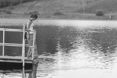 Rear view of boy on lake