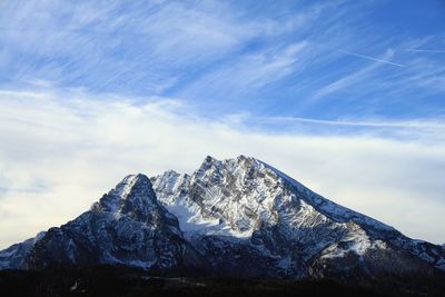 Low angle view of snowcapped mountains against sky