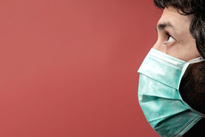 Man with mask, covid-19 protection, coloured background