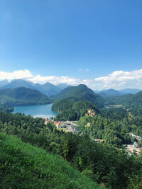 Scenic view of landscape and mountains against blue sky