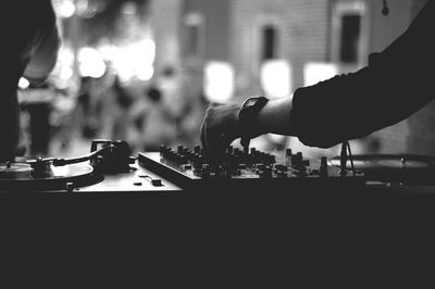 Close-up of hands playing piano at night