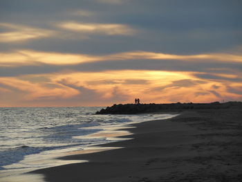 View of sea against cloudy sky during sunset