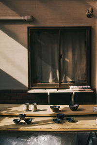 Empty seats on table against wall