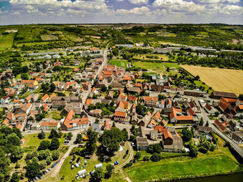 High angle view of houses and trees in city