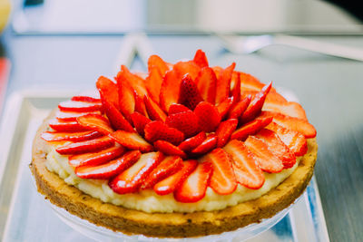 Close-up of red flower in plate on table