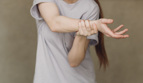 Midsection of woman with arms raised