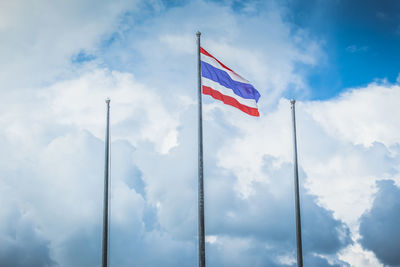 Low angle view of flag flags against sky