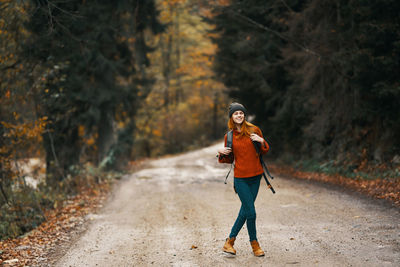 Full length of woman walking on footpath