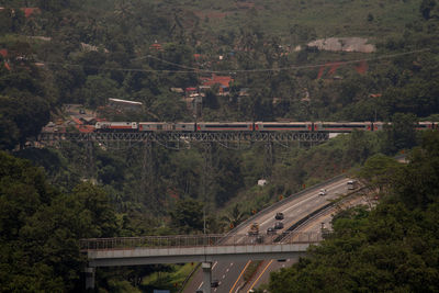 High angle view of bridge over road in forest